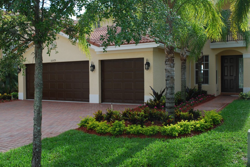 welcome home! beautiful landscaping and freshly painted garage doors and front door greet you at your new home.