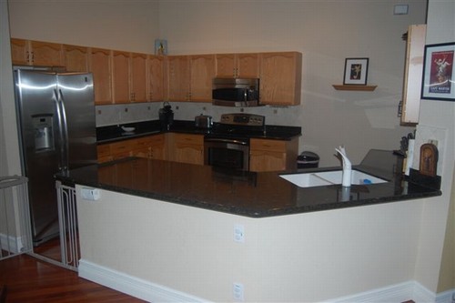 kitchen the kitchen is gorgeous and features granite counters with full tile backsplash, wood cabinets and newer stainless steel high efficiency appliances.