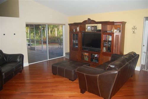 family room the large family room is off the kitchen and includes sliders that lead out to the screened patio.