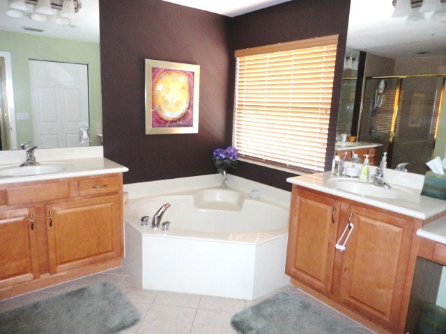 master bath the master bath has separate vanities as well as a roman tub and upgraded cabinets and tile.