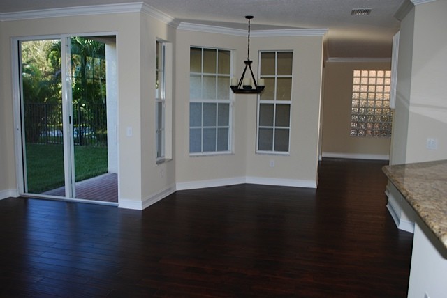 breakfast area with large windows overlooking the backyard.