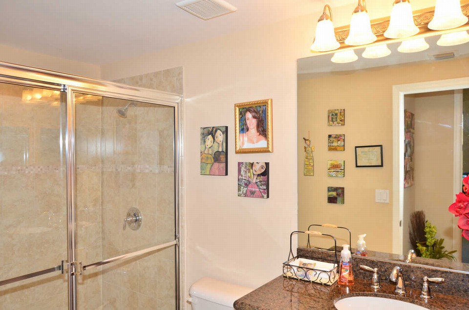 !st floor guest bathroom the guest bathroom has granite countertops, wood cabinets and upgraded shower tile with listello.