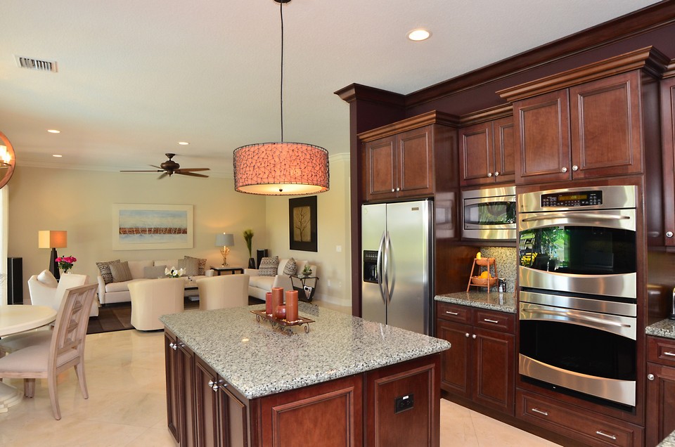 kitchen the gorgeous kitchen is a chef's dream. there are beautuful 42 cappuccino wood cabinets with crown molding above as well as fluted columns, pull outs and soft close drawers.