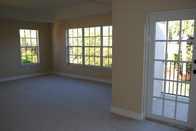 the huge master suite features a sitting area and access to upstairs balcony.