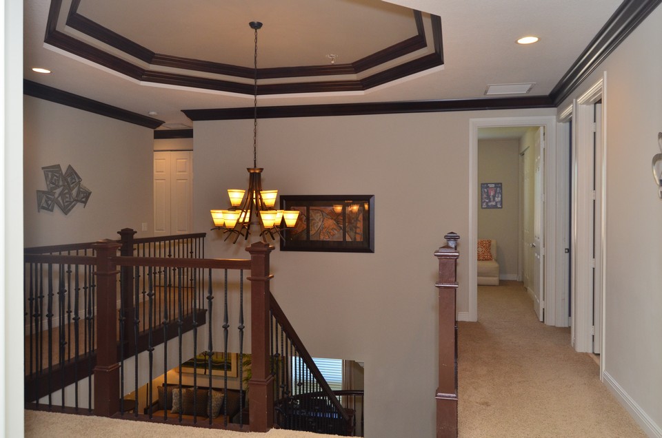 upstairs notice the beautiful oak wood banister and wrought iron staircase.