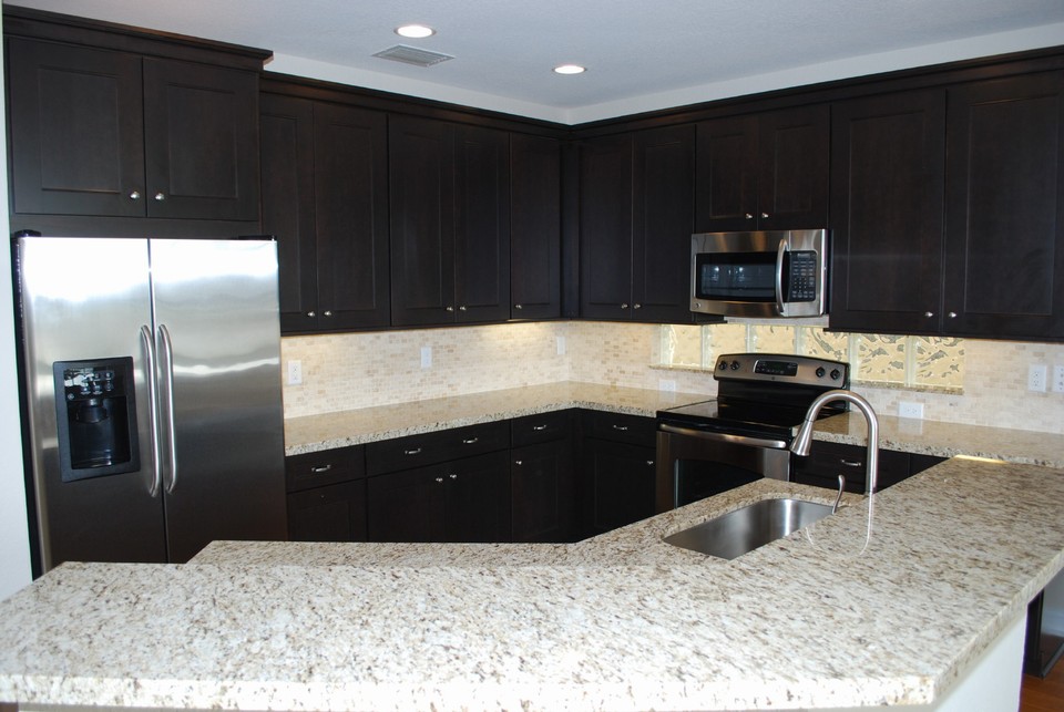 kitchen this stunning kitchen has been completely redone and includes granite counters with full mosaic brick tile backplash, all new stainless steel appliances, and custom wood cabintery with soft close drawers.